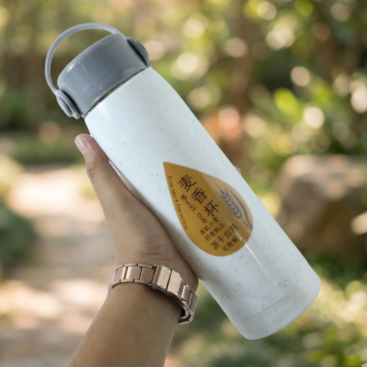 Portable water bottle with phone holder, side view