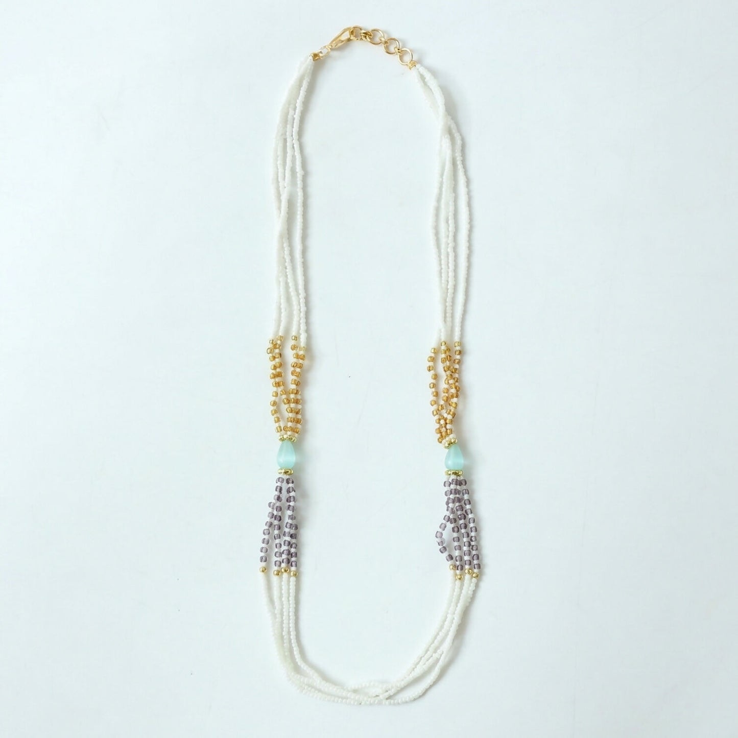 Pearl necklace with pastel lavender accents in soft light