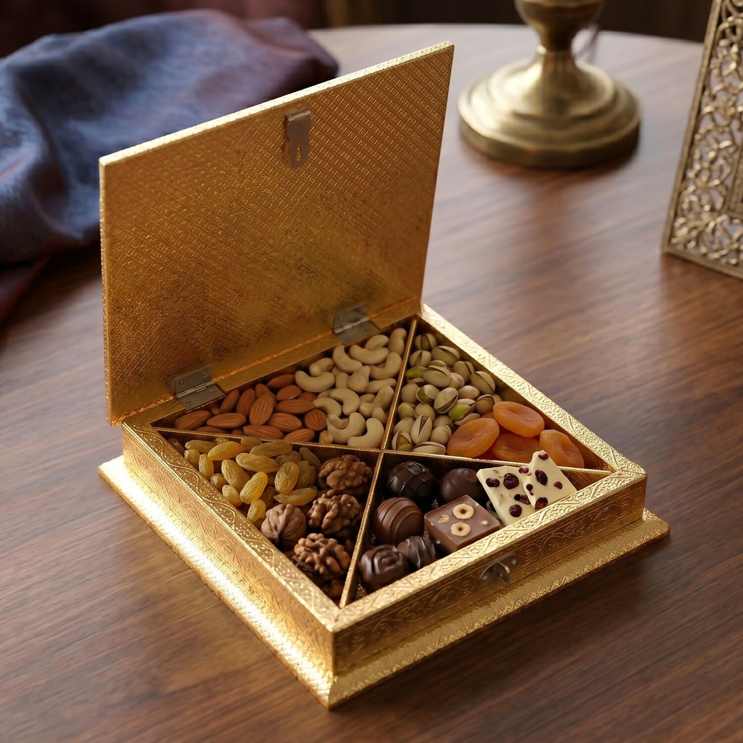 Golden floral embossed metal box open showing interior storage
