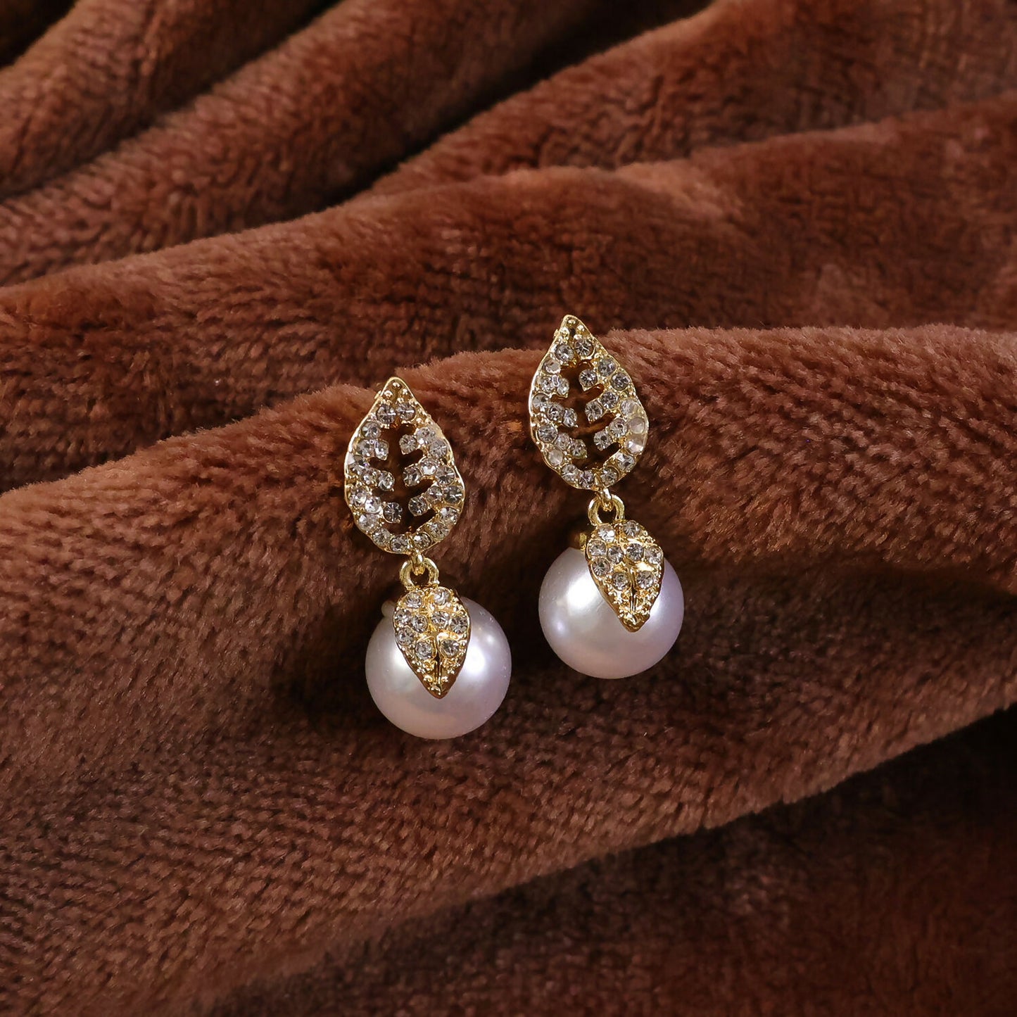 Earrings displayed with wedding attire