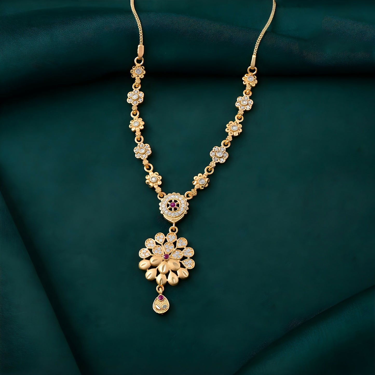Front view of elegant gold-tone floral pendant necklace set with designer chain detailing