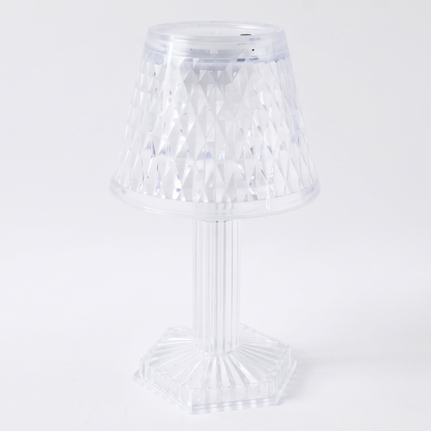 Crystal table lamp on a shelf, lit up