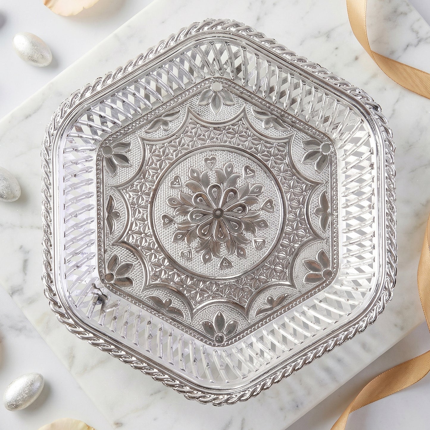 Beautiful silver tray with footed base and intricate floral embossing for serving and decoration