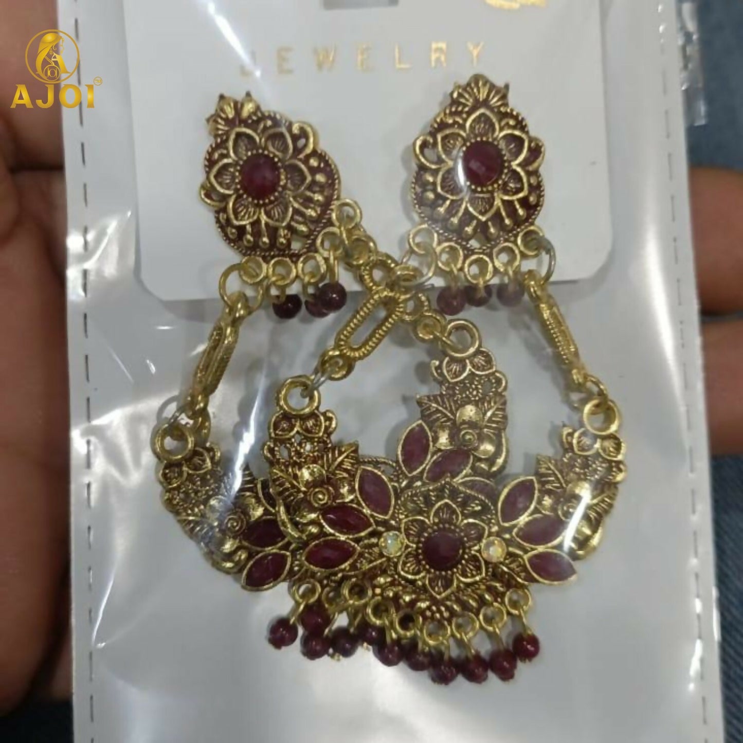 Maroon bead tassels hanging from vintage floral chandbali earrings
