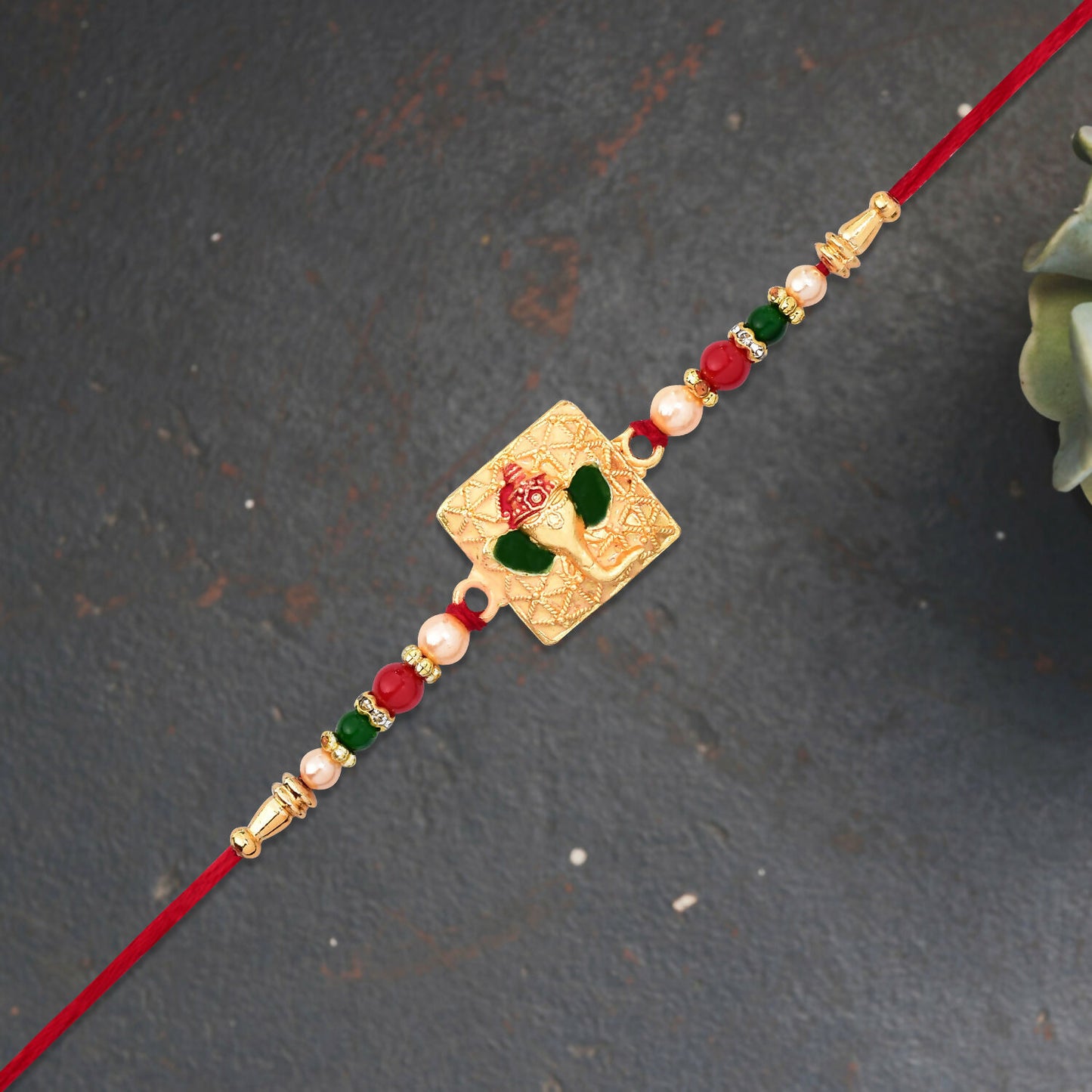 Golden Ganpati Rakhi with colorful bead accents