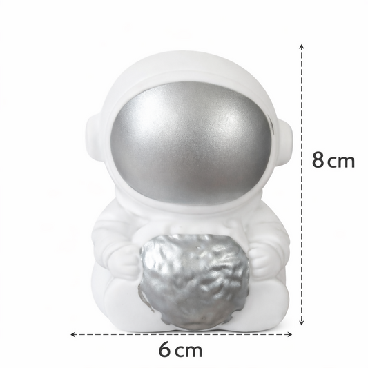 Compact silver astronaut moon night light on bedside table