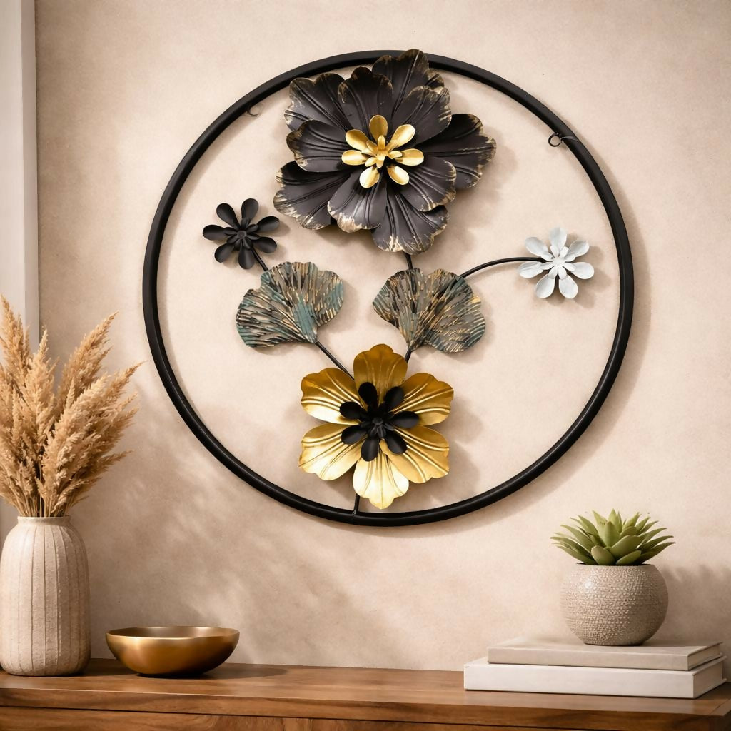 Metal floral round wall art in black and gold on white wall