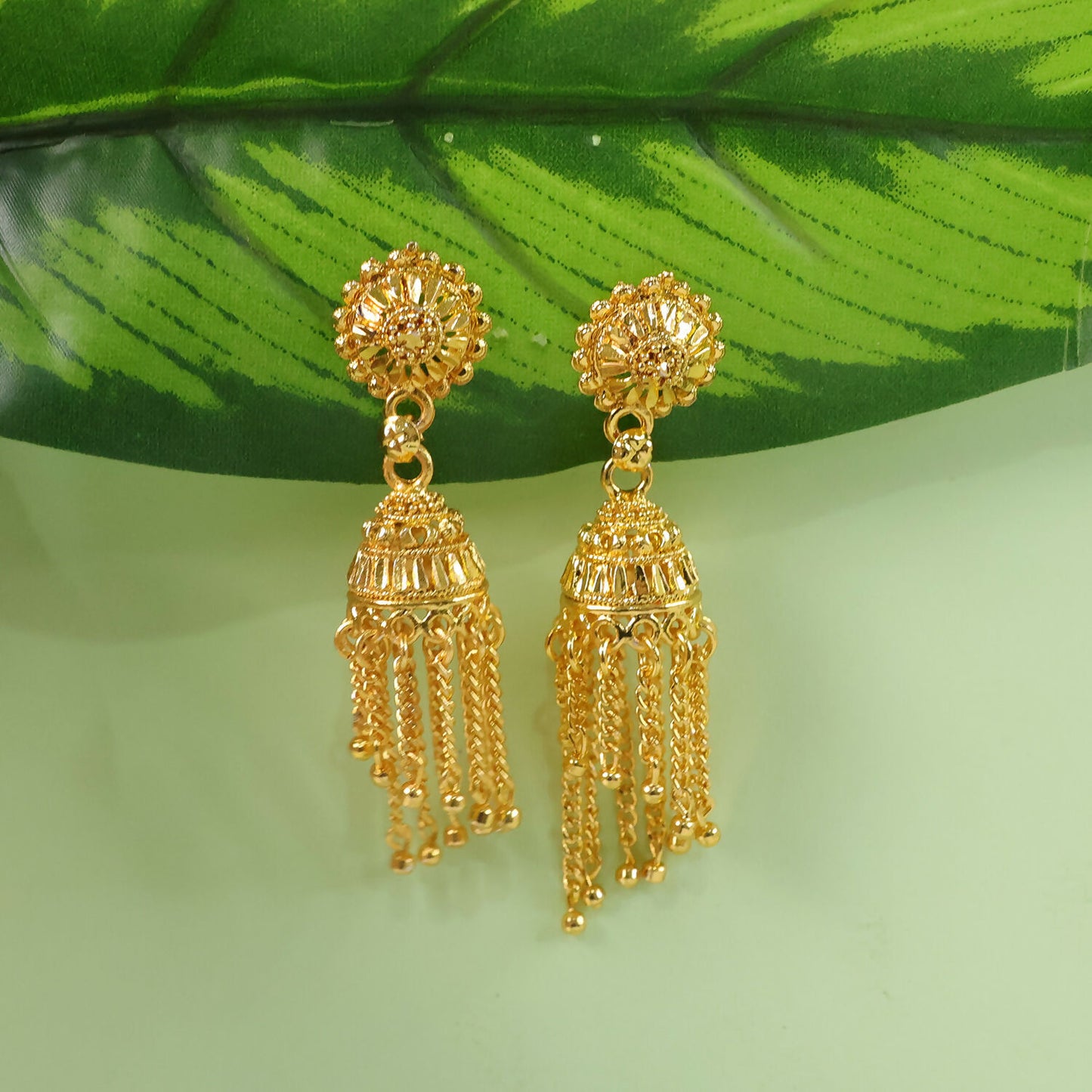 Gold plated long chain jhumka earrings displayed on a white background