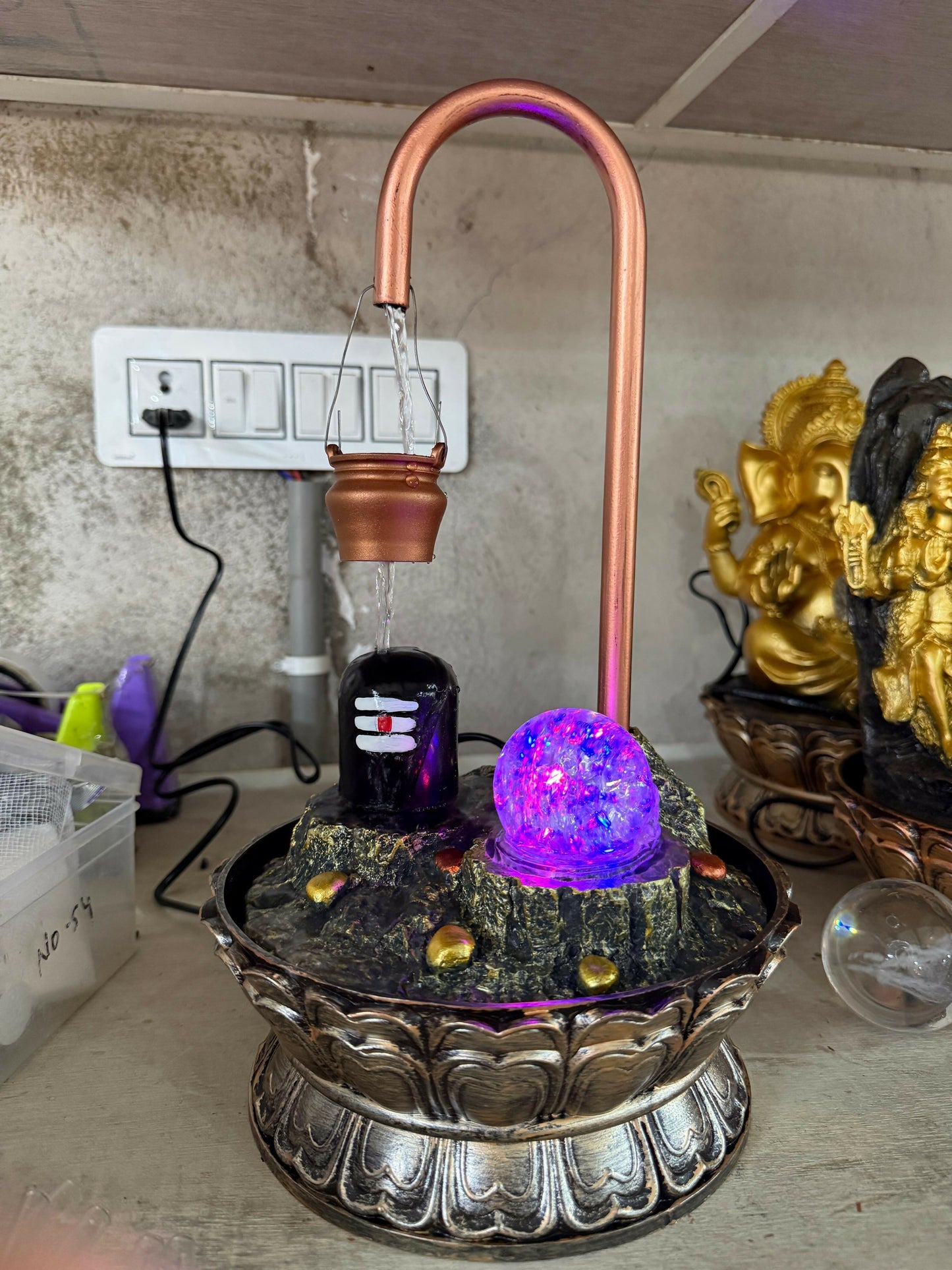 Shivling tabletop water fountain with LED crystal ball glowing at night