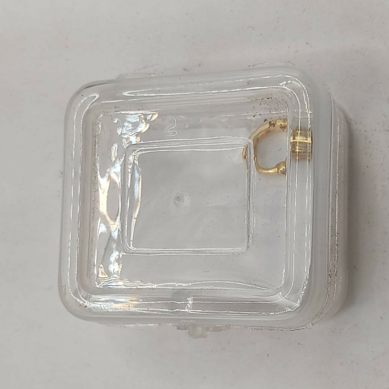 Gold plated crystal huggie-style nose ring displayed with high-polish finish and stones