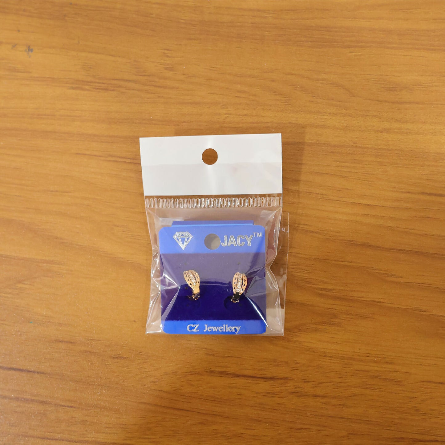 Pair of gold finish CZ studded hoop earrings on white background