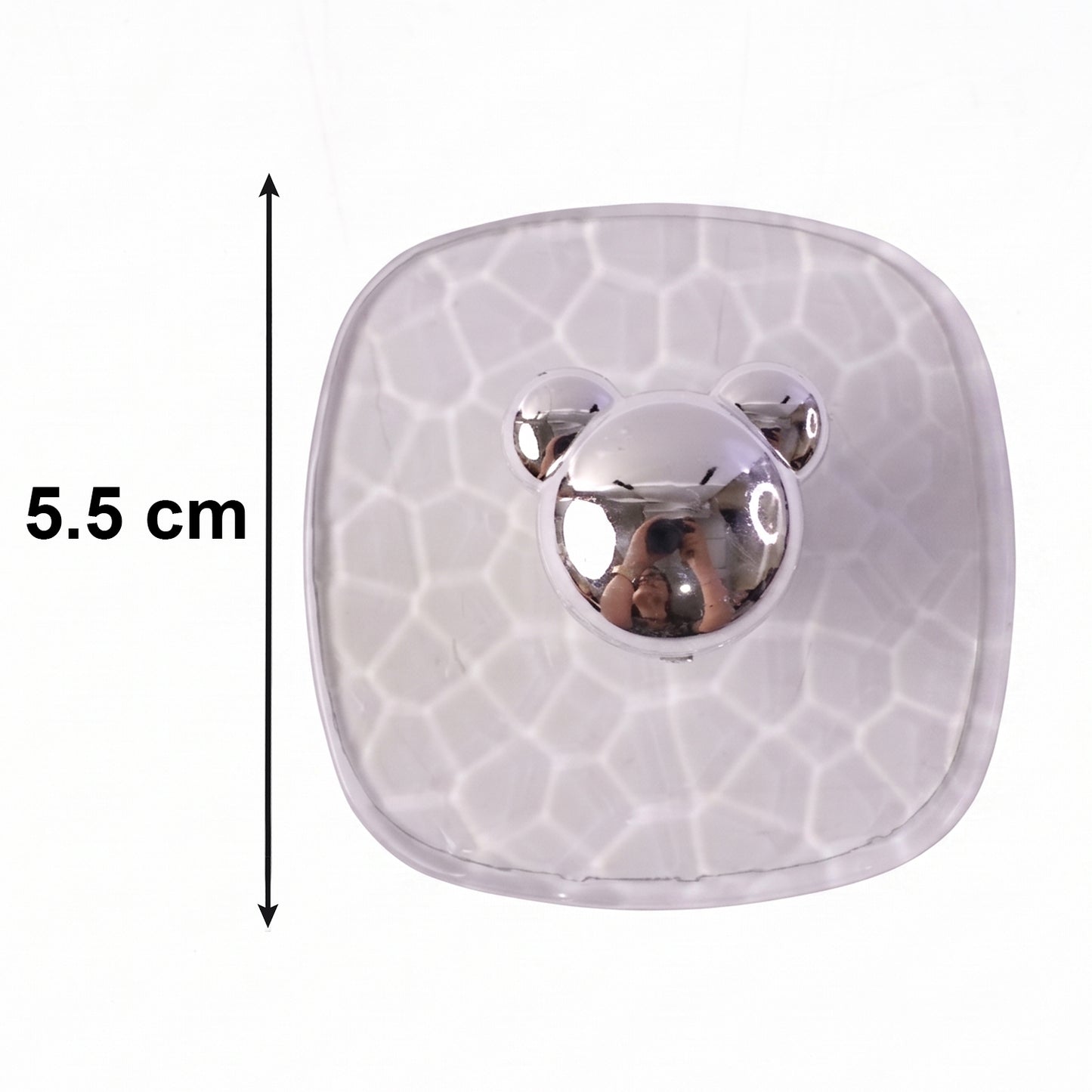 Side view of clear plastic adhesive wall hooks mounted on a wall