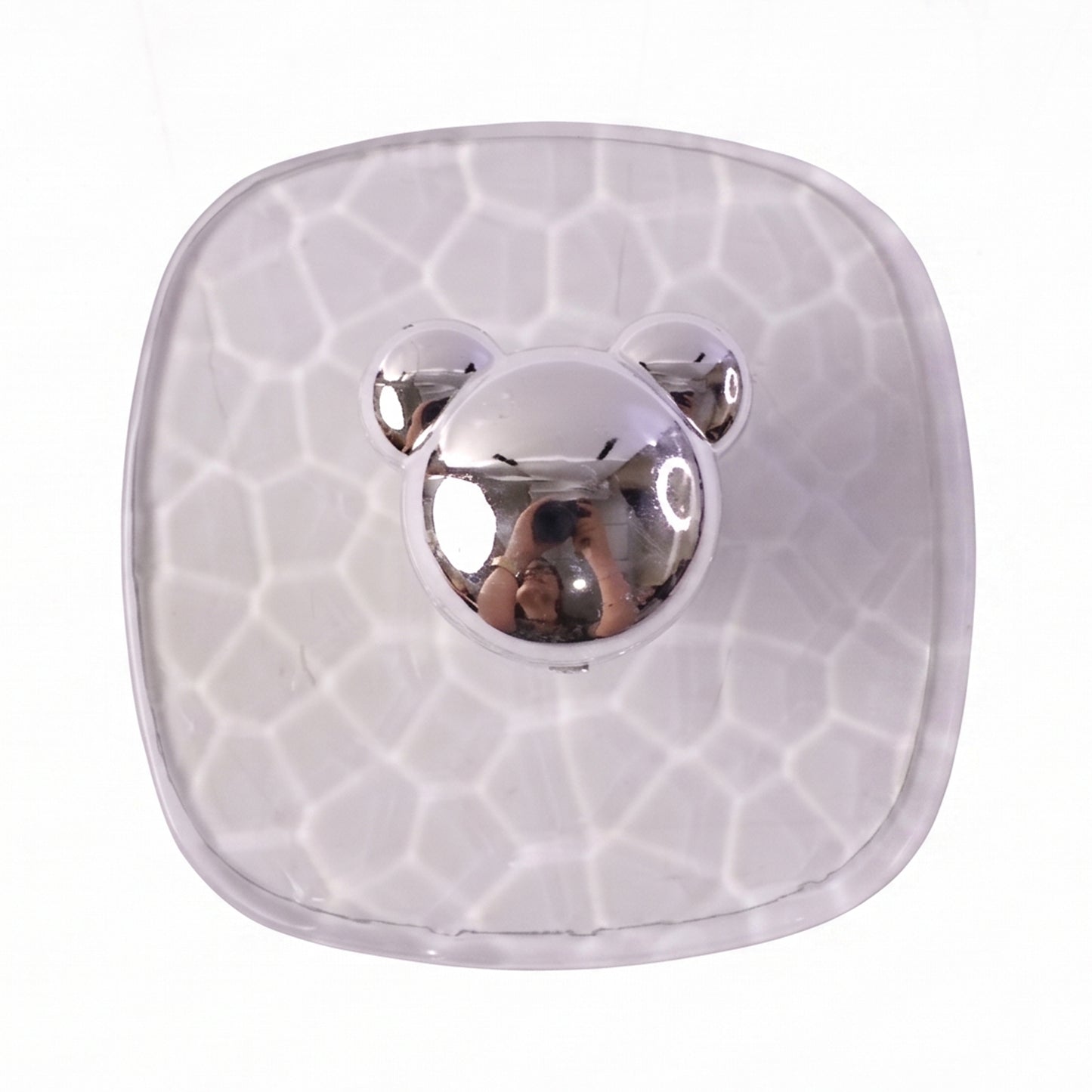 Multiple clear adhesive wall hooks attached on a bathroom wall