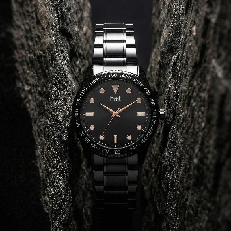 Front view of classic analog wrist watch with black dial and metal strap