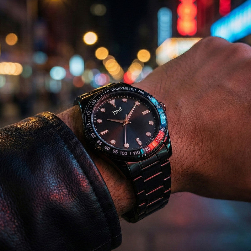 Black metal strap wrist watch showcasing tachymeter bezel and analog display