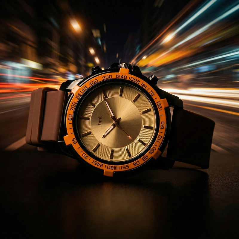 Top angle of sporty wrist watch featuring multicolour tachymeter bezel and brown strap