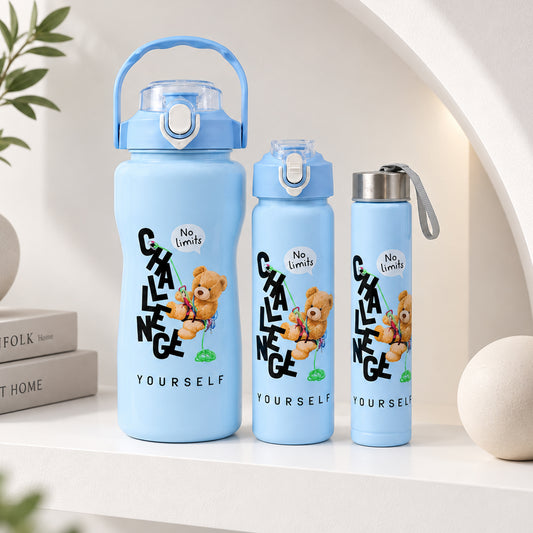 Three light blue water bottles of varying sizes with a teddy bear graphic and text on a white shelf.