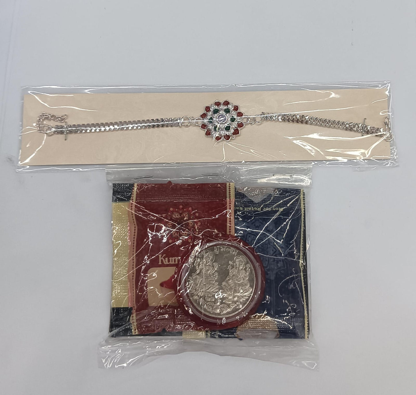 Complete Rakhi gift combo with bracelet rakhi, tilak set, coin and chocolate treat