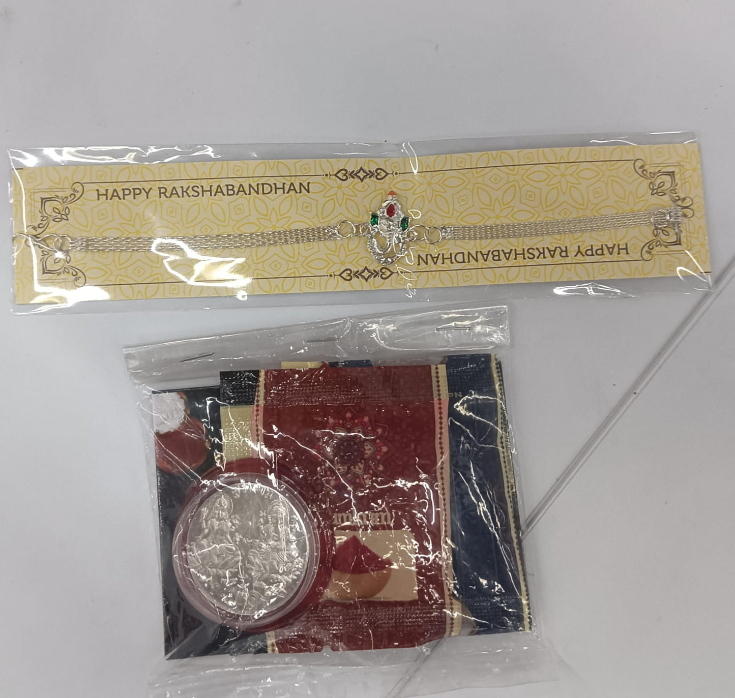 Complete Ganpati Rakhi Combo with silver bracelet rakhi, tilak set and chocolate treat