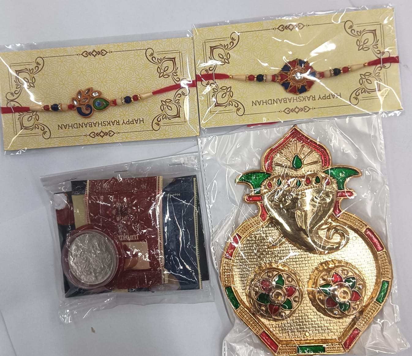 Lord Ganesh pooja thali and Rakhi set components arranged for auspicious Raksha Bandhan rituals