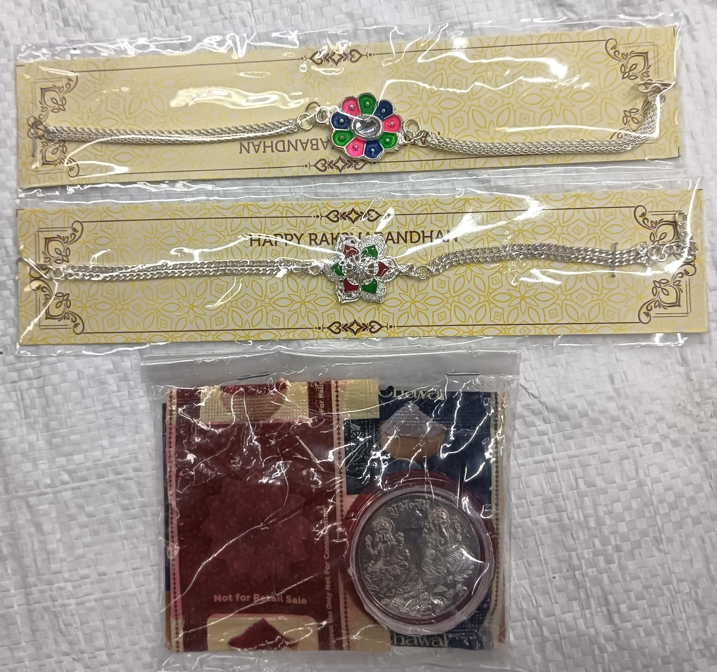 Rakhi Gift Combo with 2 Stylish Floral Rakhis for Brother – Includes Silver Coin, Roli Chawal & Greeting Card,Rakhi Gift Combo