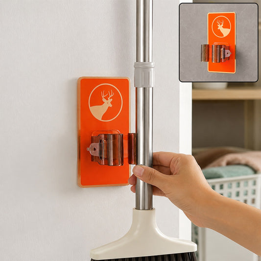 A hand placing a mop into an orange deer-themed wall-mounted holder on a white wall, with an inset showing the holder alone.
