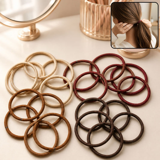 A variety of elastic hair bands in shades of brown, beige, and maroon on a vanity table.