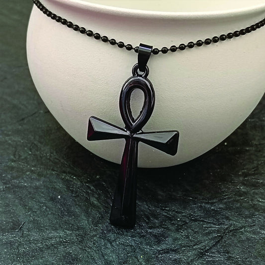 Black pendant necklace featuring the Egyptian Ankh symbol on a men's chain