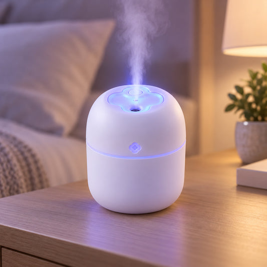 A white humidifier with blue light and mist on a wooden nightstand next to a bed.