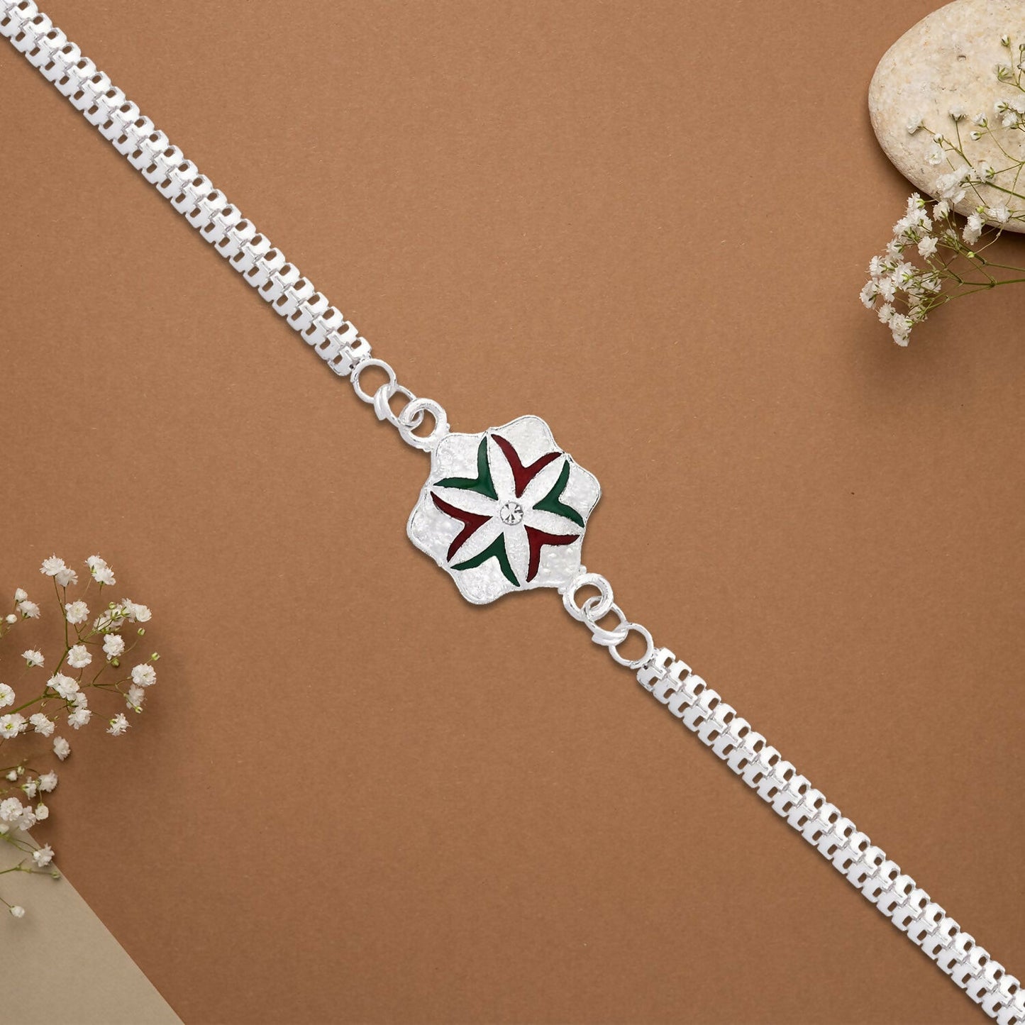 Close-up of silver chain detail on elegant flower rakhi