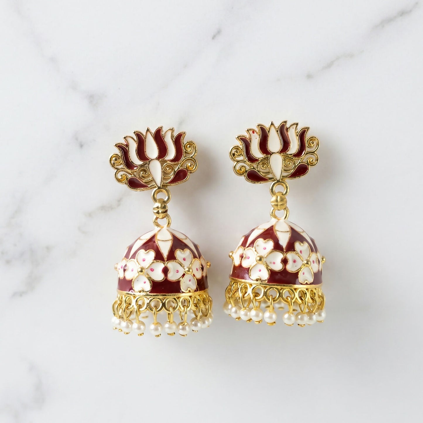Side view of maroon lotus jhumka earrings with pearl beads