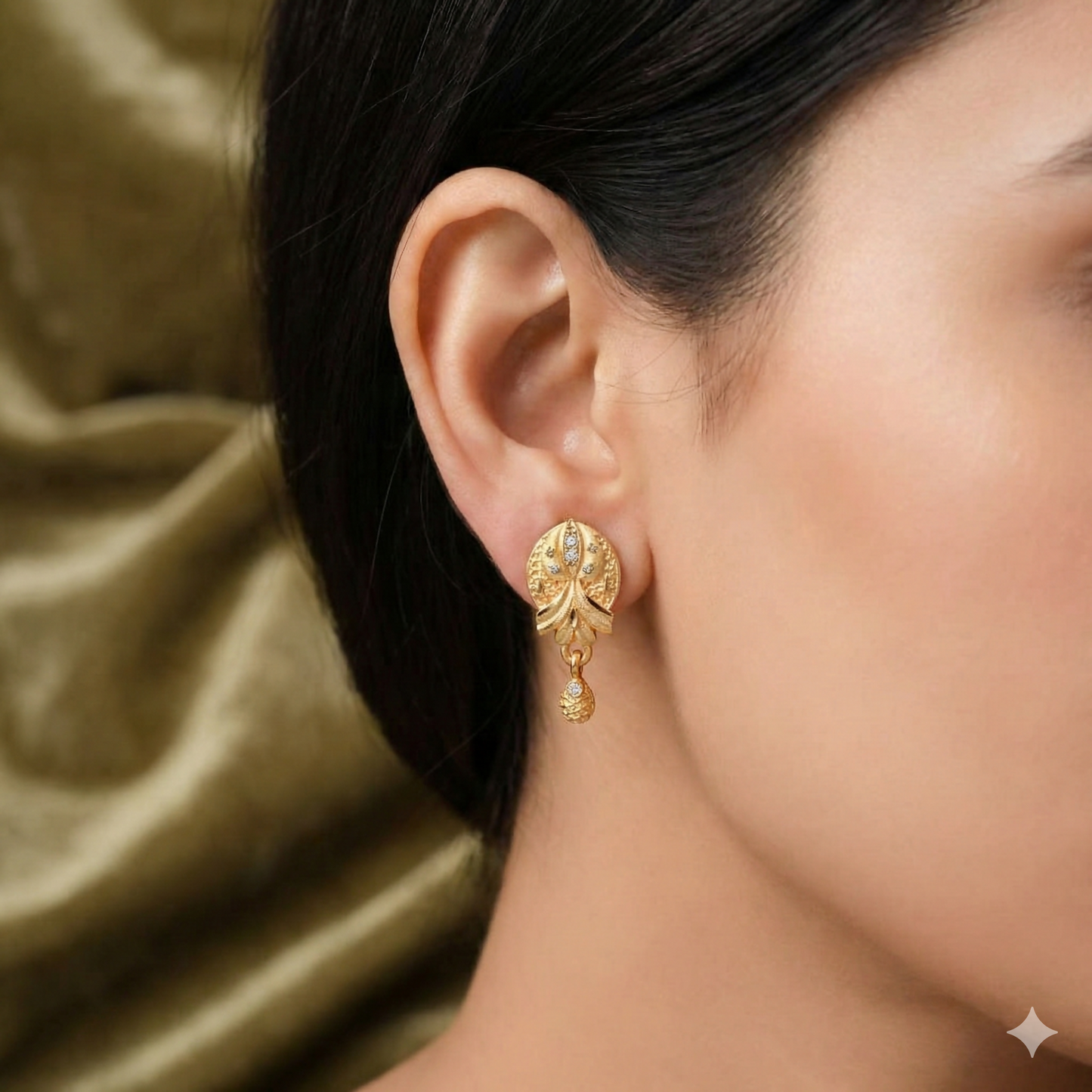 Side view of gold plated ethnic floral drop earrings highlighting delicate patterns