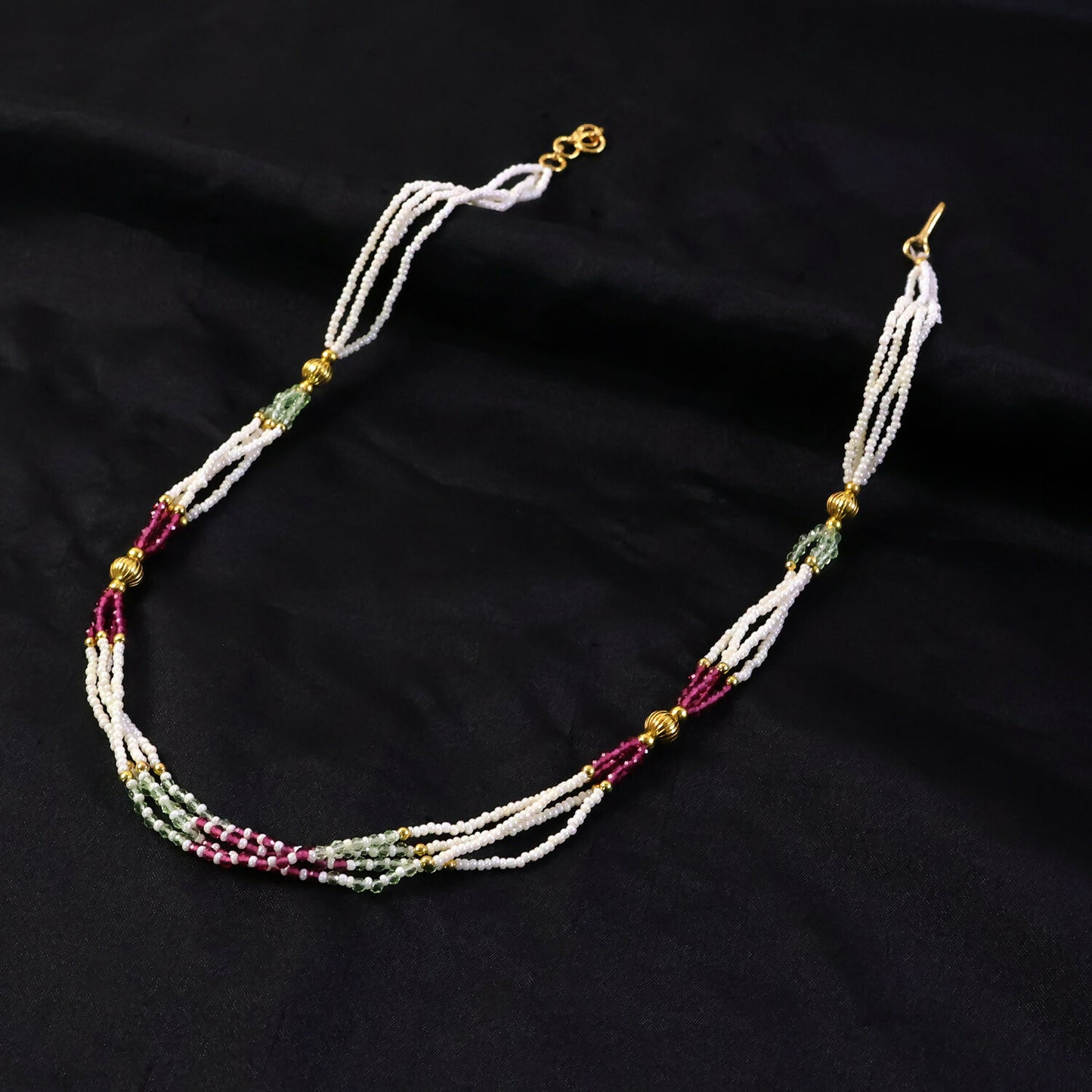 Close-up of pearl beads with dual-tone pink and mint accents on mala necklace