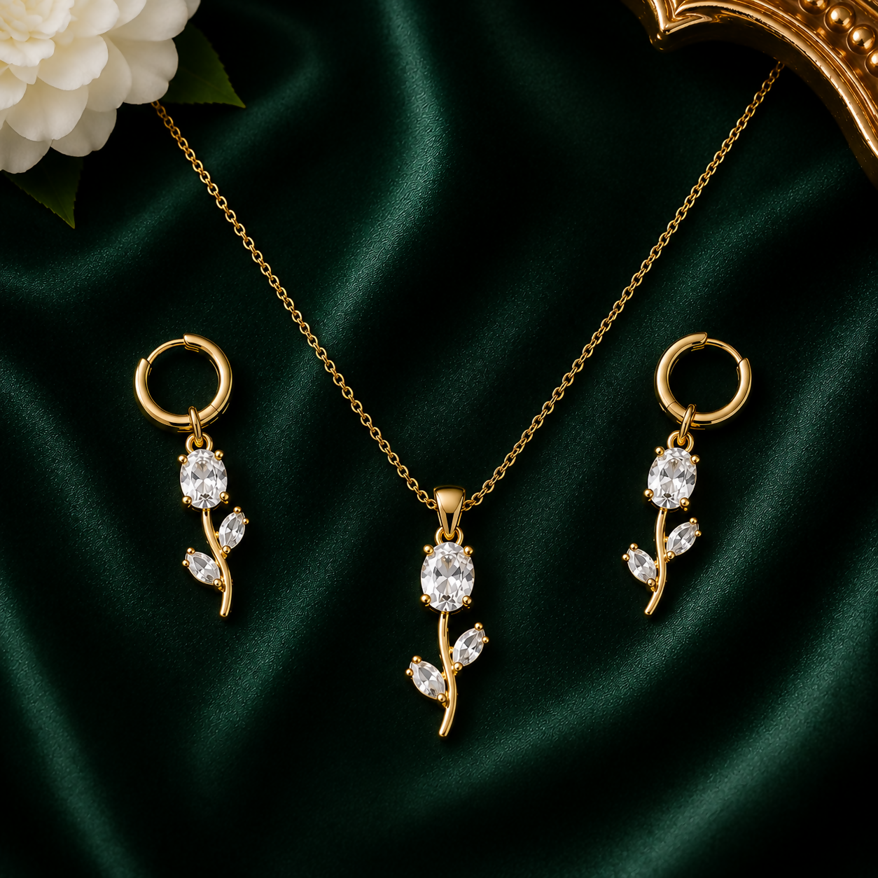 White crystal floral pendant necklace set with matching earrings displayed on a white surface.