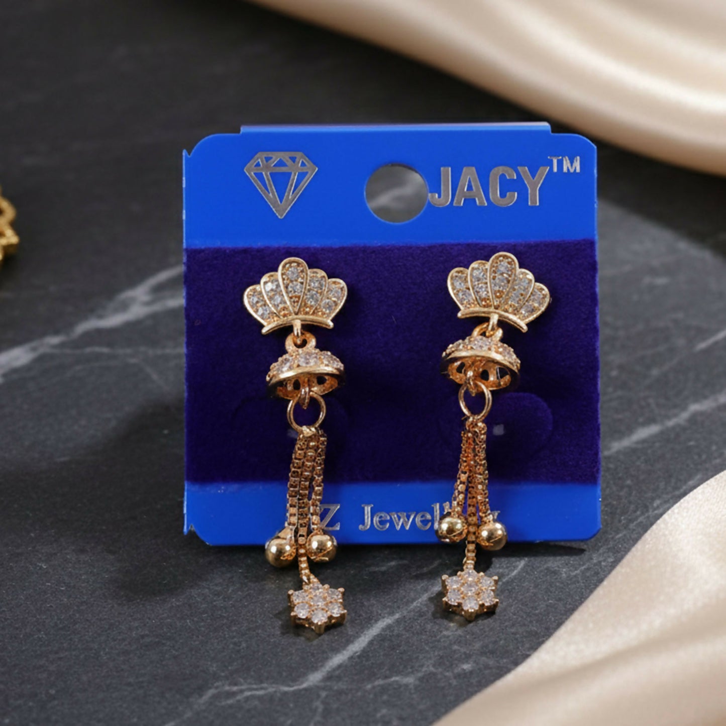 Elegant crown-shaped gold finish earrings adorned with crystal tassels hanging gracefully