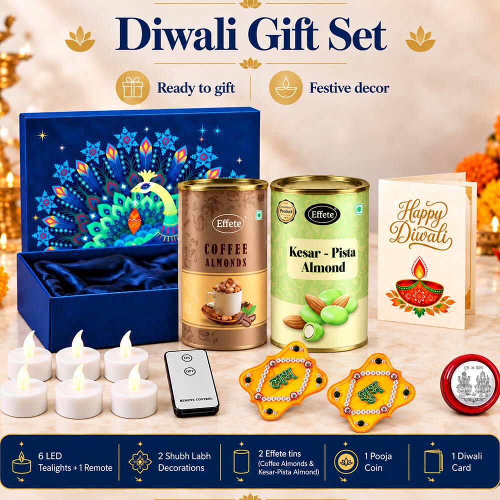 A blue gift box with a peacock design, two almond tins, a Diwali card, six LED tealights, a remote, two yellow Shubh Labh