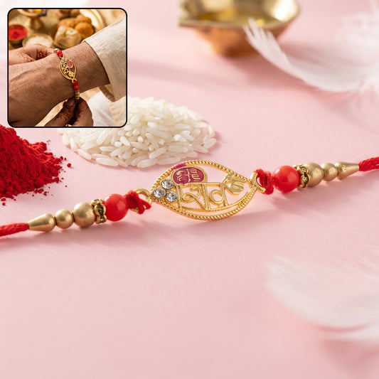 Gold Leaf Shiv Rakhi with pearl sides and red beads close-up