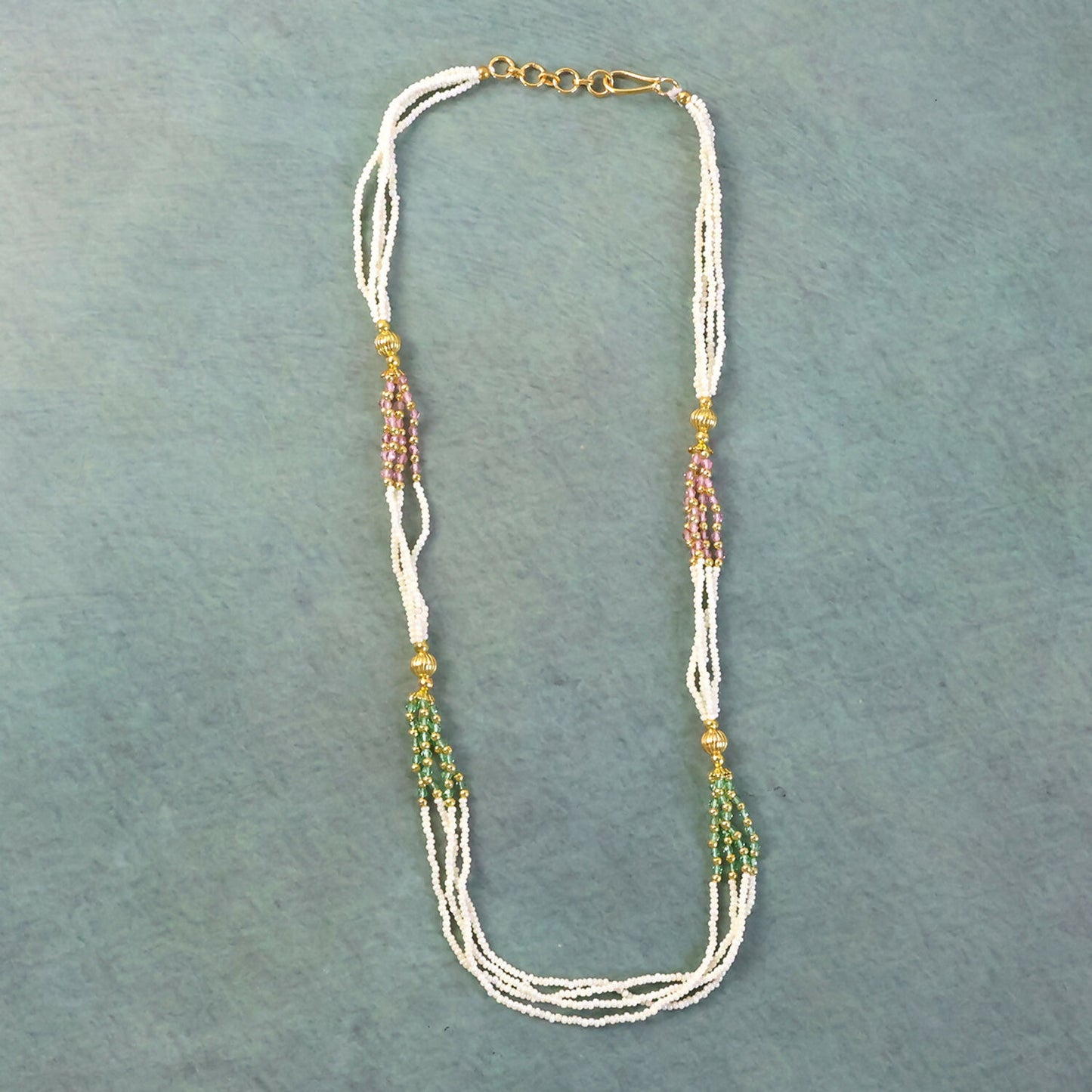Close-up of traditional mala necklace beadwork with gold-toned details