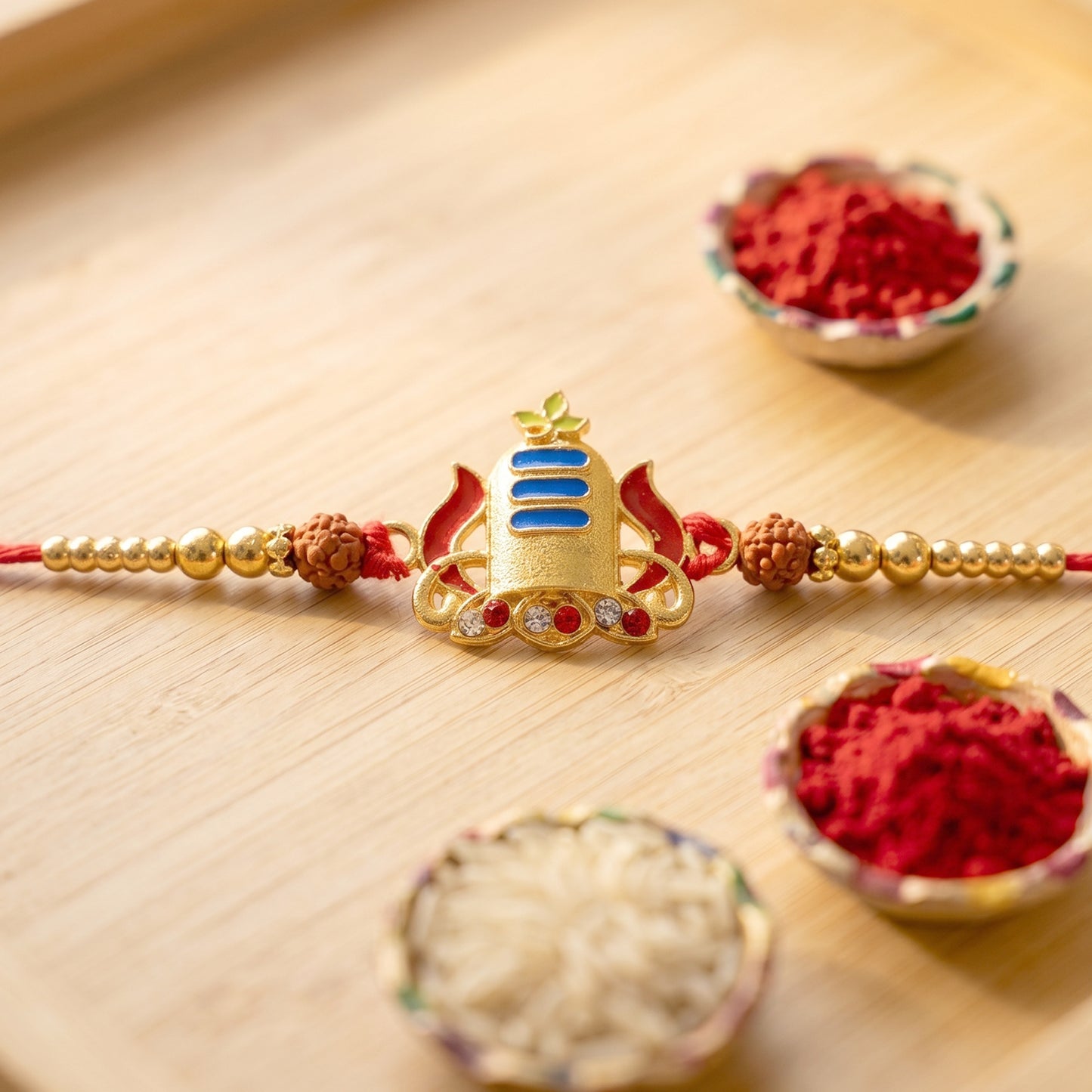 Gold Shivling Rakhi with Blue Tilak and Rudraksha Beads