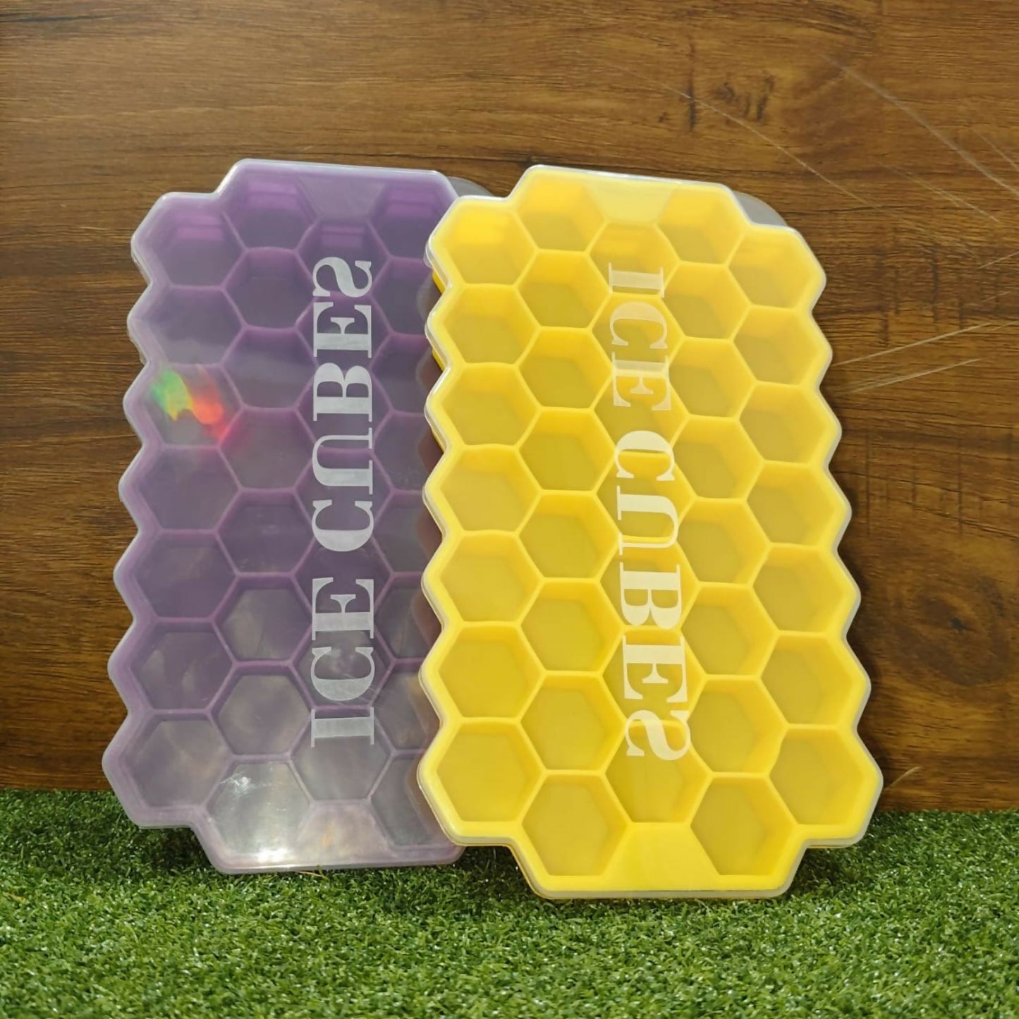 Honeycomb ice trays being filled with water for freezing