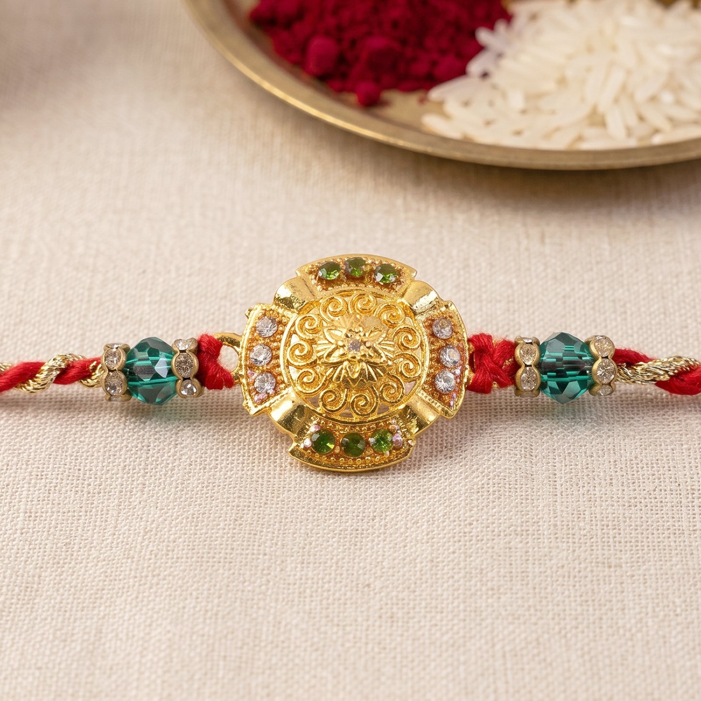 Traditional Gold Floral Coin Rakhi with Green Stone Beads