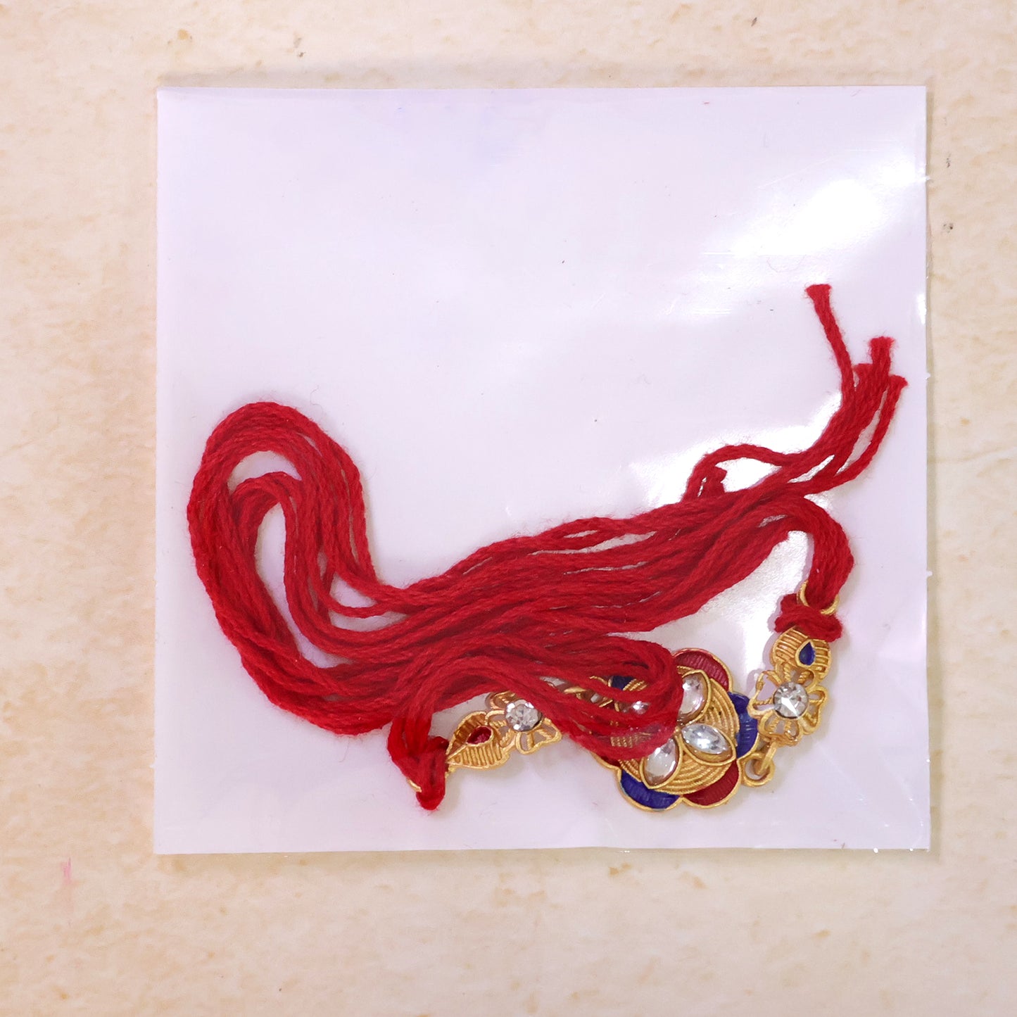 Ornate Rakhi with Floral Medallion, multicolor stones and display look for Gift Use