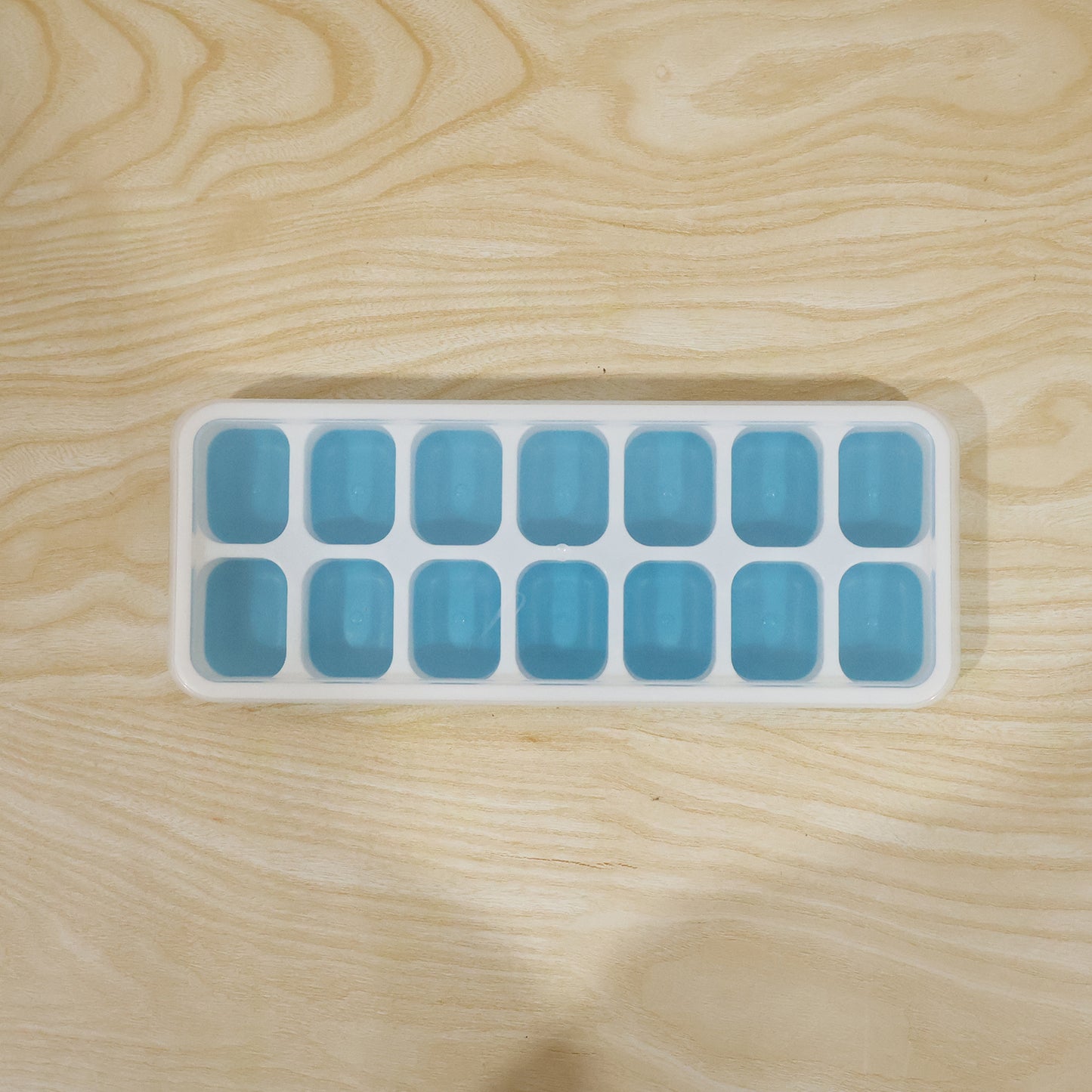 Blue ice cube tray in use