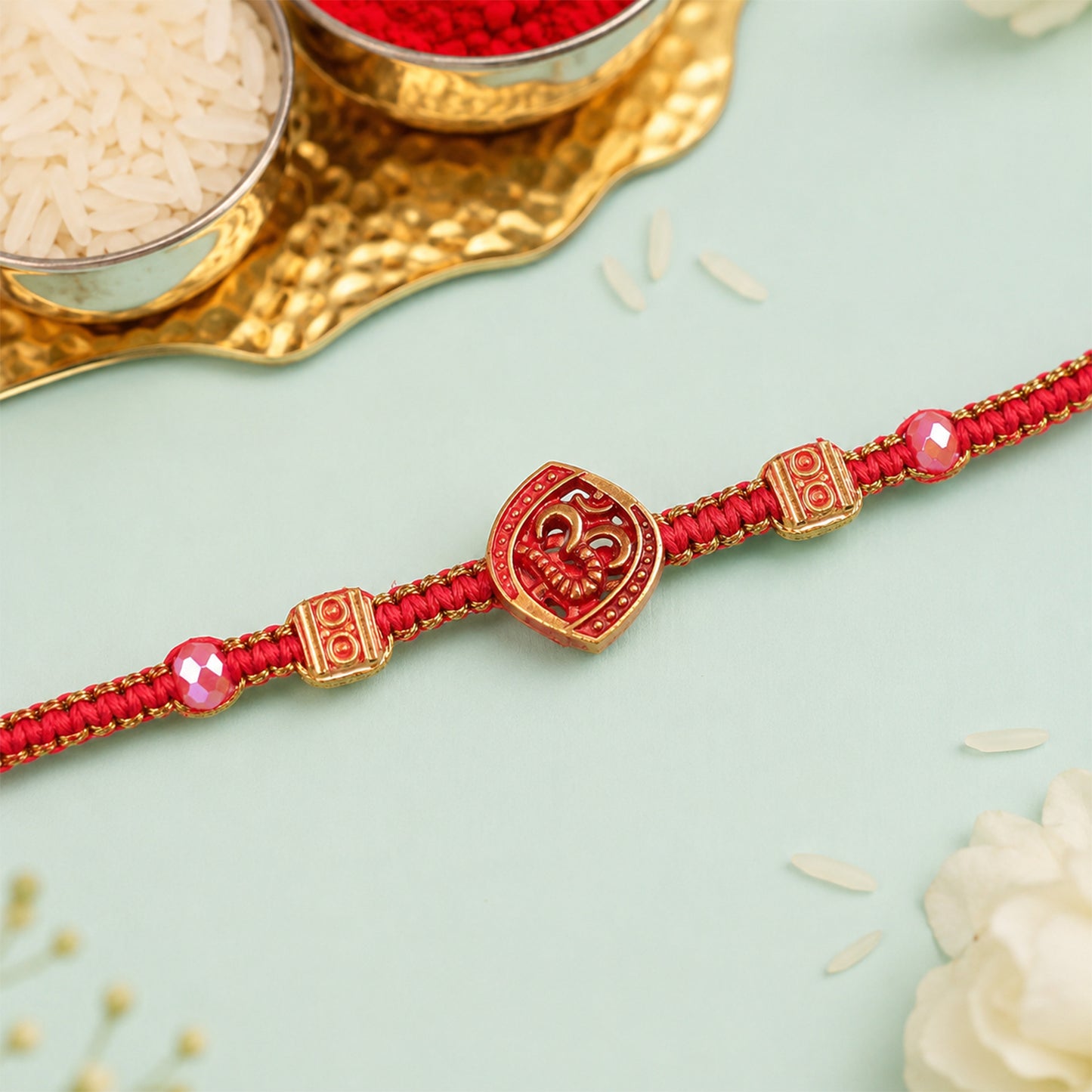 Red Swirl Stone Rakhi with Golden Detail and Beautiful Festive Centre Styling