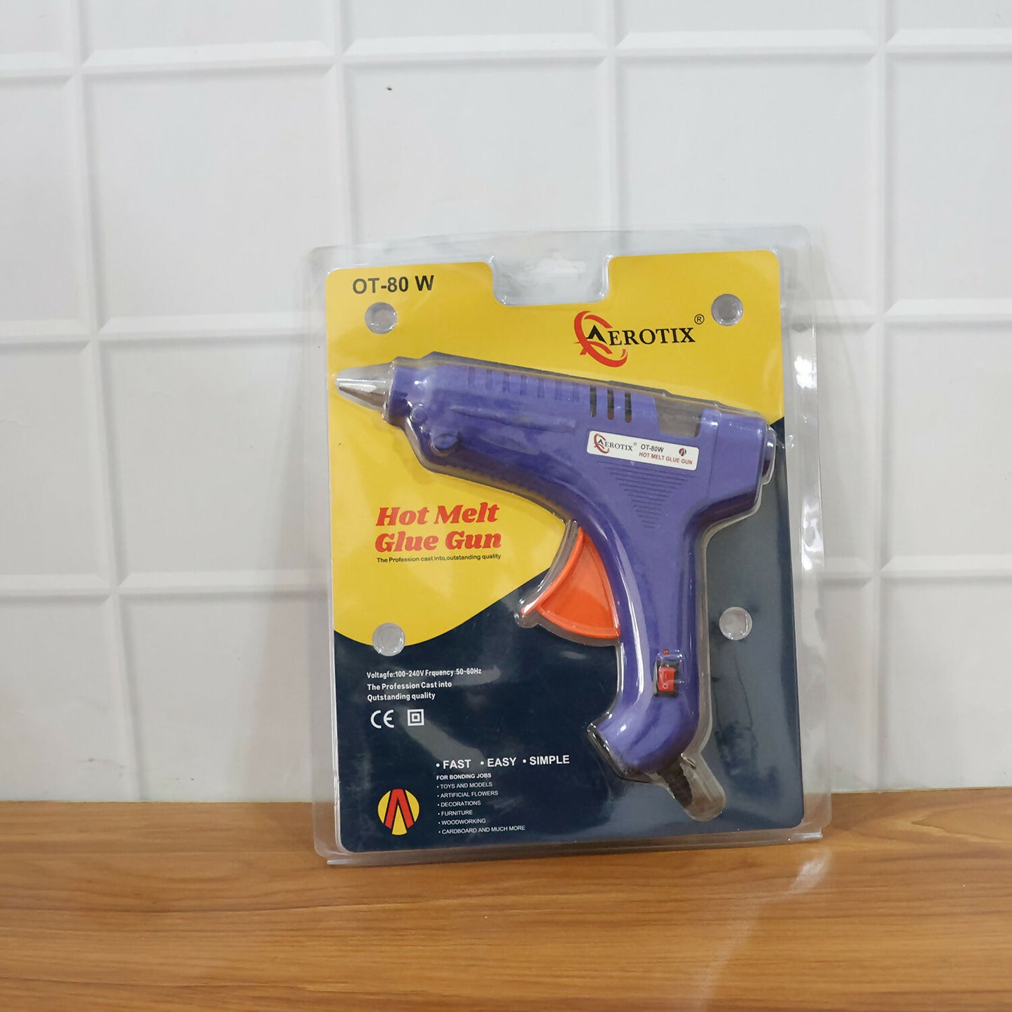 Trigger-controlled electric hot melt glue gun in use