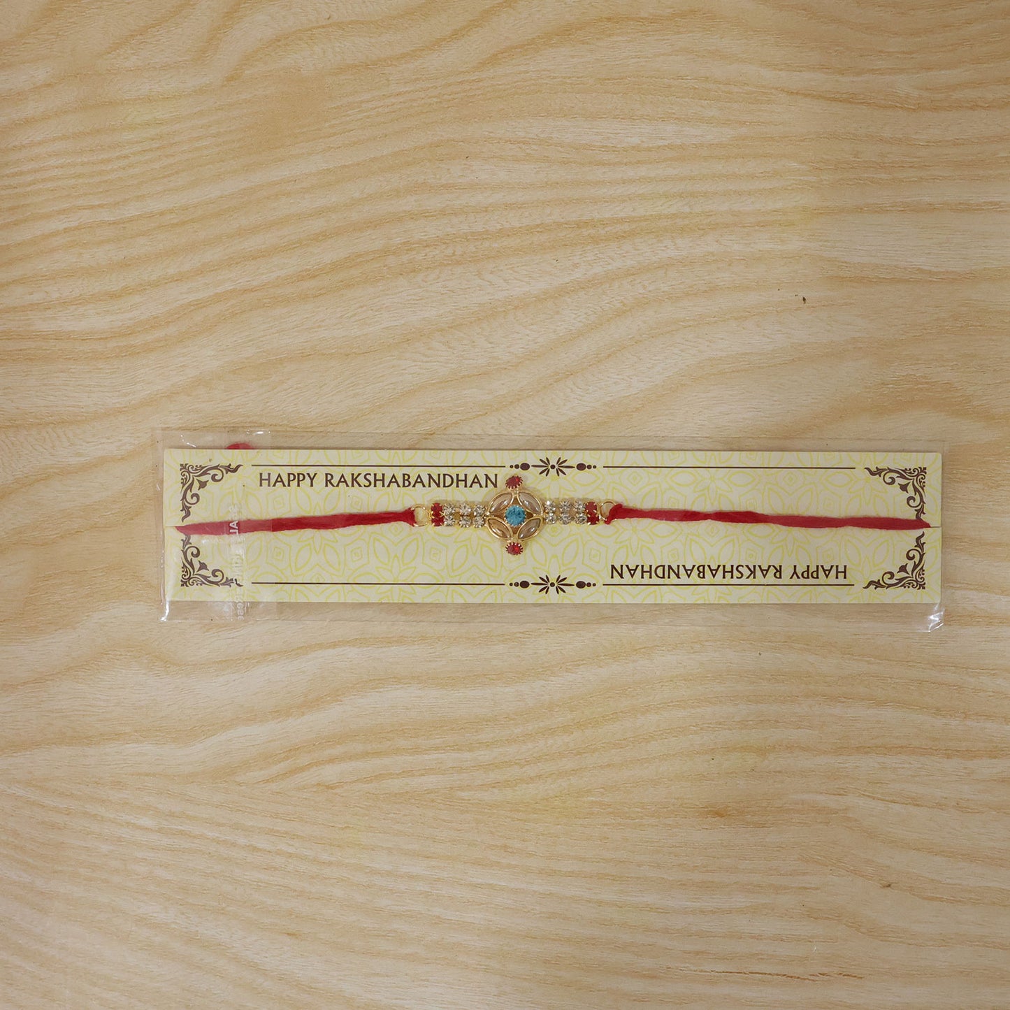 Blue Center Floral Kundan Rakhi with Red Stones and Pearl Ends