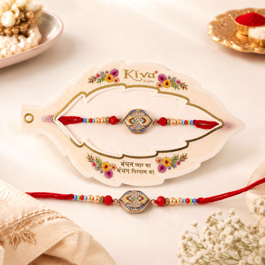 Close-up of a single Kundan Rakhi with a maroon stone centre and delicate pearl beads.