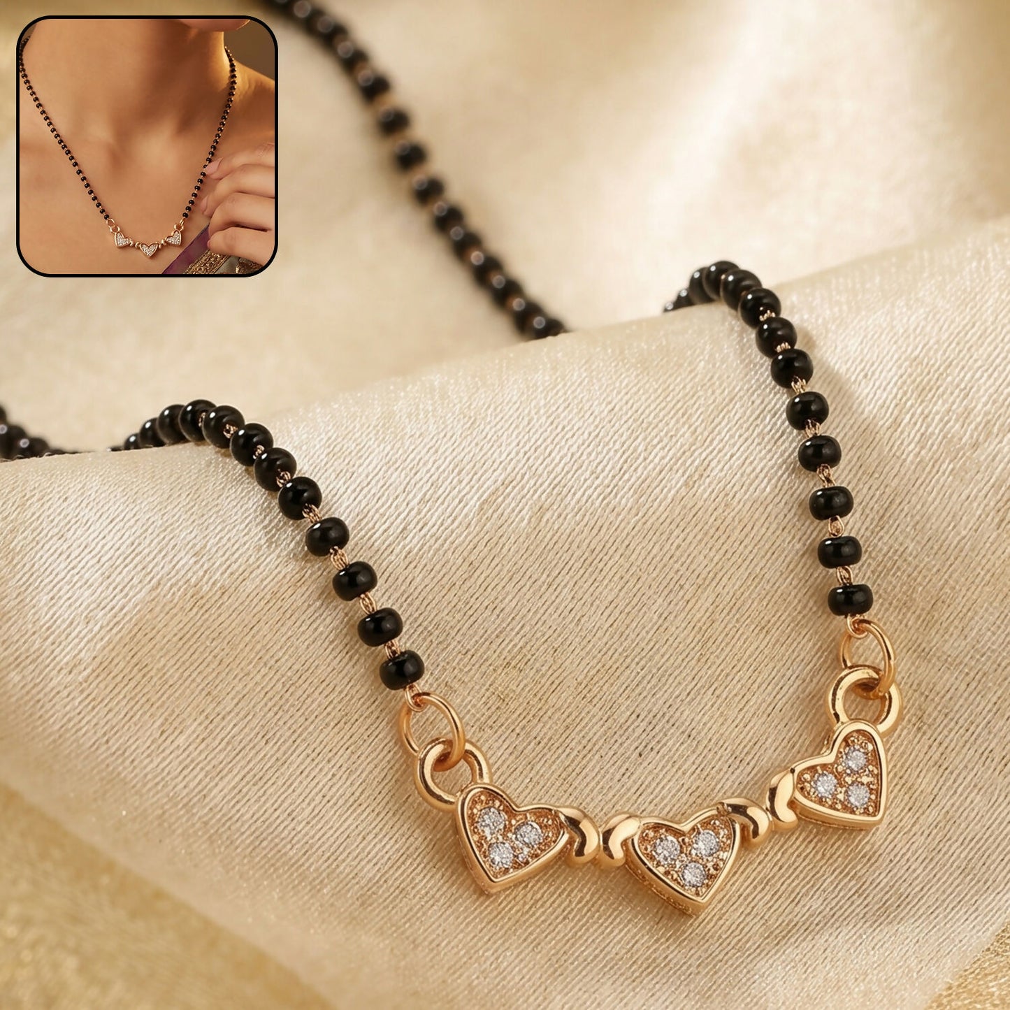 Elegant mangalsutra necklace with triple heart pendant and crystal embellishments.