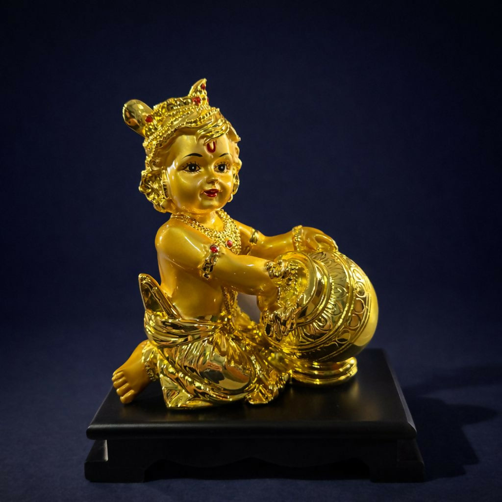 Side view of Bal Krishna statue with butter pot in golden finish