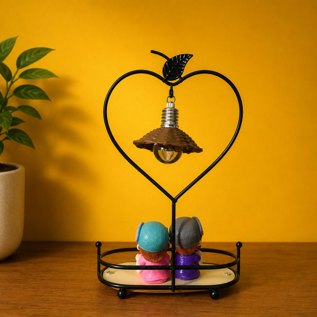 Heart-shaped metal frame table lamp with warm hanging bulb